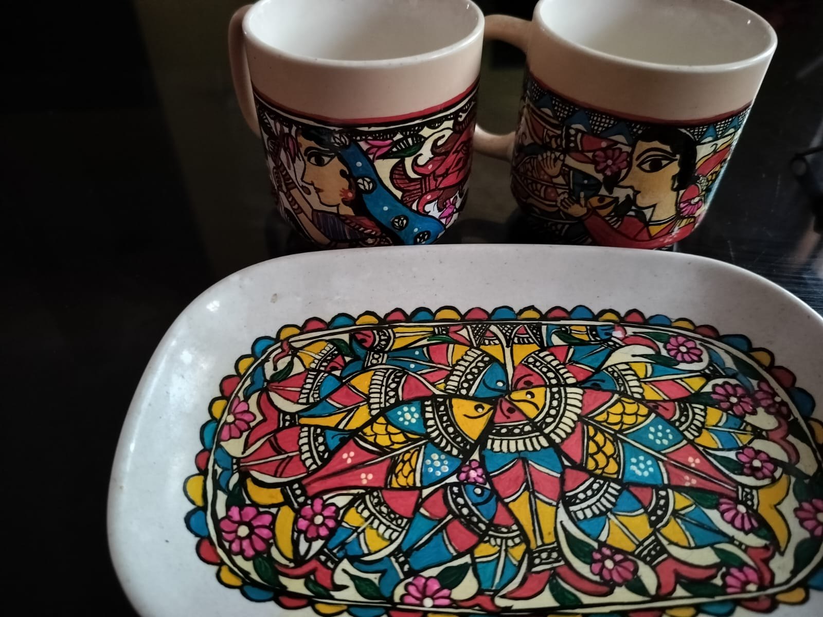 Mithila art painted on cups and a plate