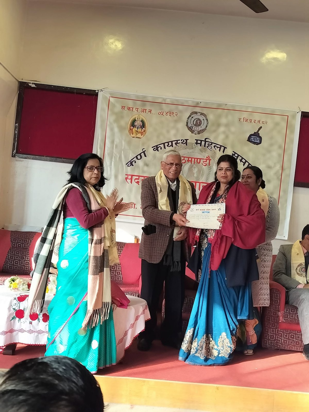 Chanda Kumari Karn receiving a certificate at an art event